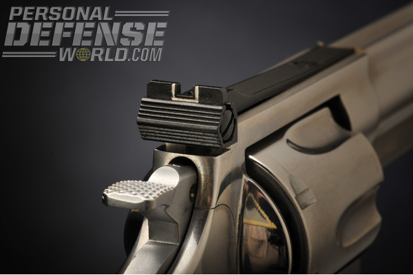 The rear sight has horizontal serrations to keep the glare of the sun from ruining your sight picture. Note the notch has a white outline.