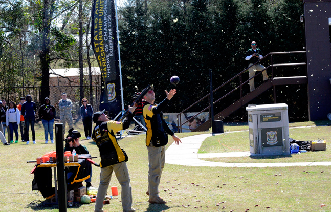 Shotgun shooters Sgt. 1st Class Mark Weeks and Staff Sgt. Josh Richmond wow the crowd as they make a salad by shooting fruits and vegetables during the 2014 Army Strong Experience March 13. (U.S. Army photo by Sgt. 1st Class Raymond J. Piper)