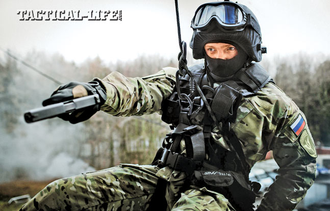 A member of an MVD OMOH unit rappels into position to engage wit his pistol. The pistol is a Glock, as Russian special units can purchase weapons from abroad.