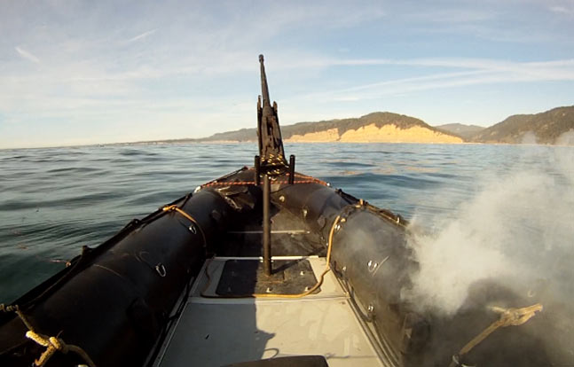 In tests off the California coast, the Lockheed Martin ADAM laser system burns through the hull of a military-grade boat. (Photo credit: Lockheed Martin)
