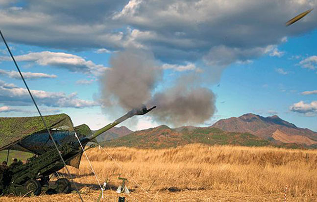 Marines fire an M777A2 Howitzer