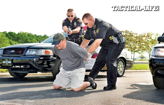 Handcuffing is best done with two officers. The restraining LEO approaches with their sidearm secured while a partner provides cover.