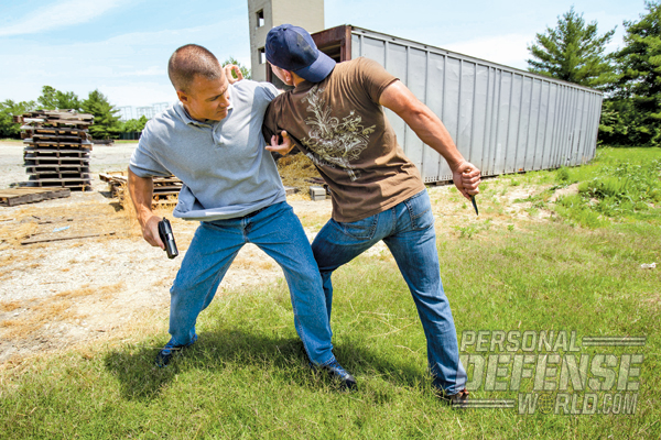 An overarm grip just above the attacker’s elbow limits his mobility and keeps you well away from a deadly knife thrust.