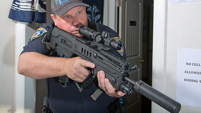 low-powered optics rifle pose