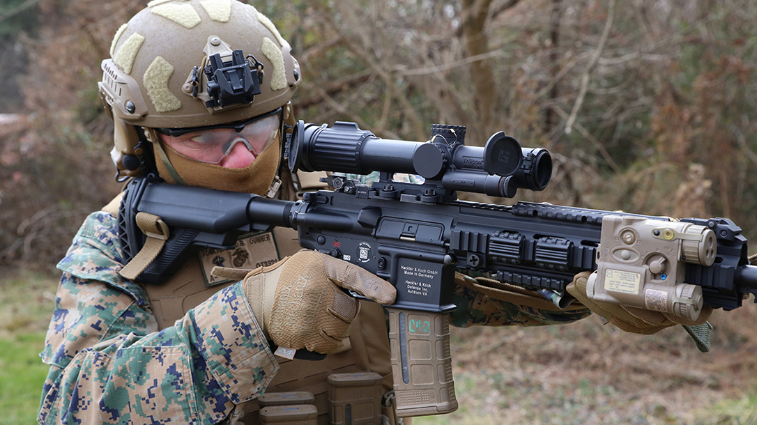 CWO4 Dave Tomlinson, infantry weapons officer at Marine Corps Systems Command, demonstrates the Squad Common Optic attached to the M27 Infantry Automatic Rifle, Feb. 10, aboard Marine Corps Base Quantico, Virginia. The SCO is an improved optic that improves target acquisition and probability of hit with infantry assault rifles. Marine Corps Systems Command began fielding the system to infantry and infantry-like units this year.