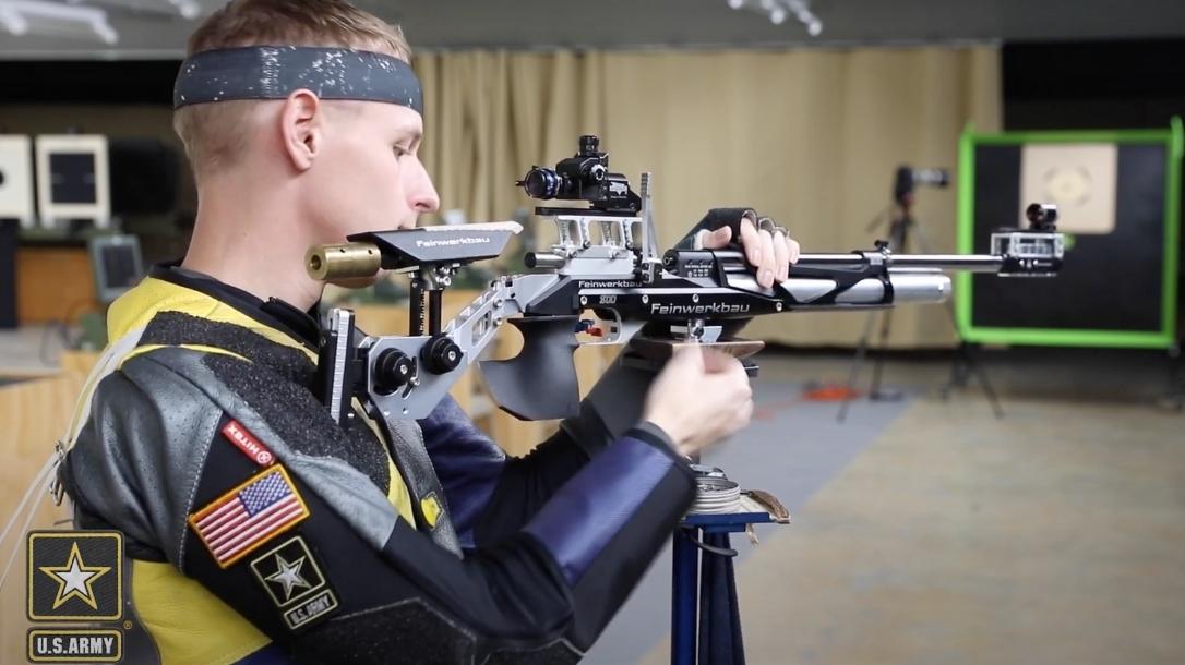Army Marksmanship Unit shooter drives a nail with his air rifle