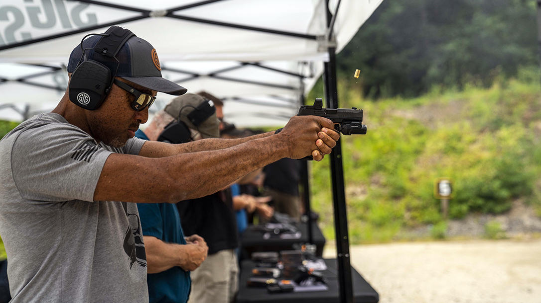 The author shoots the new SIG P365-XMACRO during a range event.