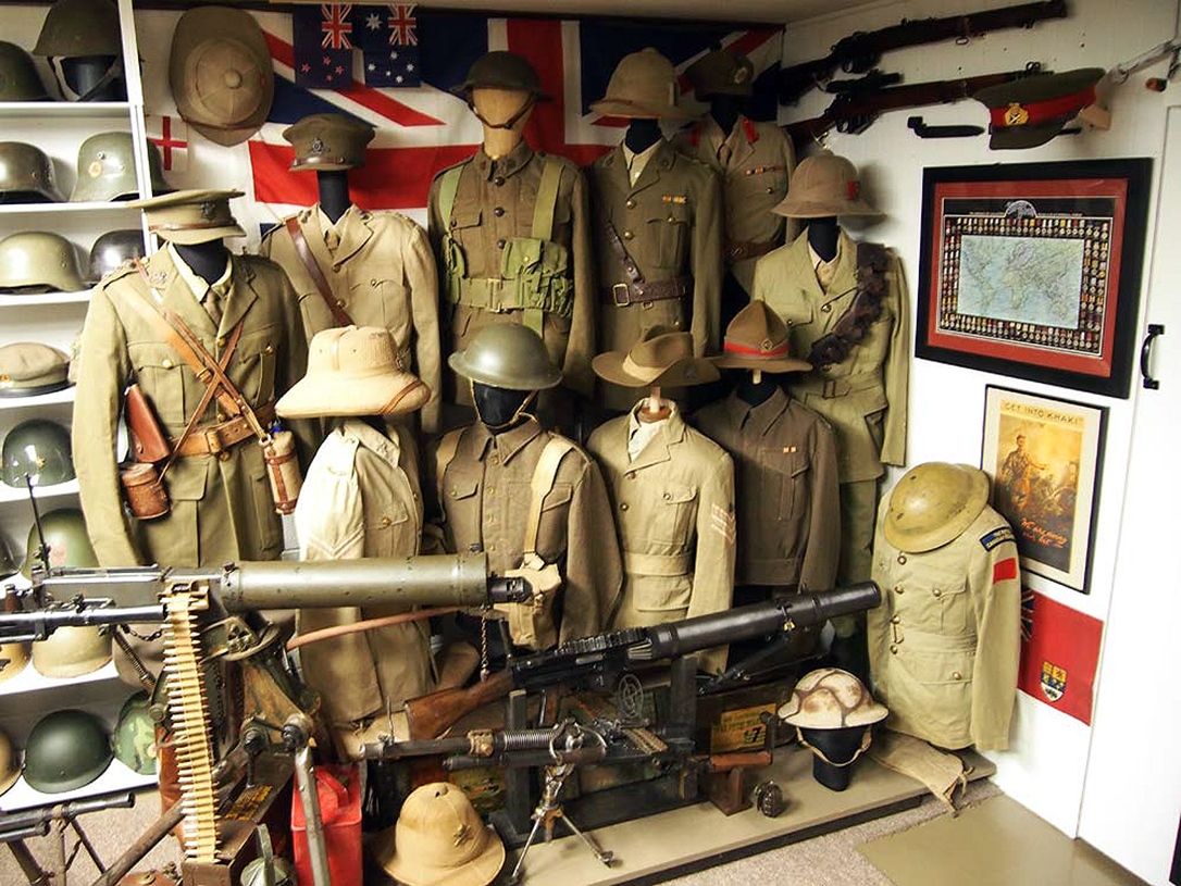 A basement bunker houses an impressive array of military uniforms and guns.