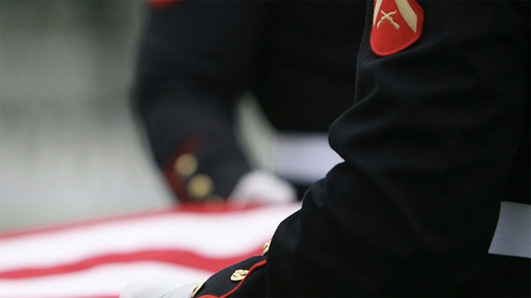 Marine Corps Body Bearers fold the flag during an internment for a deceased Marine Corps veteran.
