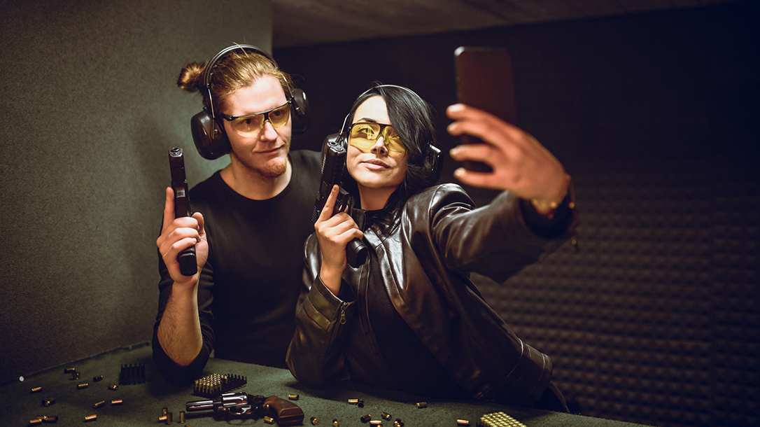Couple Enjoying Shooting Guns On Range And Taking Selfie Together