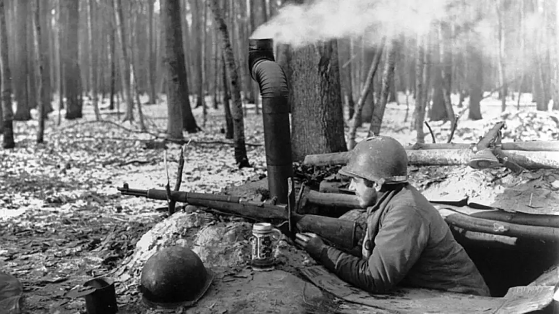An American soldier in a foxhole during the Battle of the Bulge.