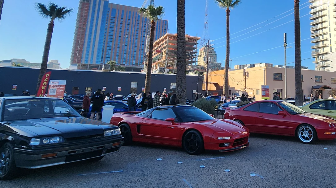 A collection of vintage Japanese cars at a cars and coffee event.