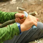 Knife Safety for Kids: An excellent example of a forehand/fist grip making a pot hook notch. The project is kept up and away from vital organs and arteries.