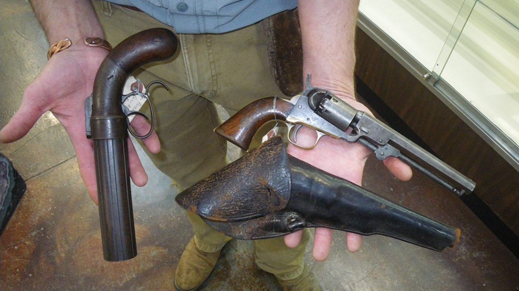 An 1830-1840 Allen dragoon pepperbox pistol known as a “pocket rifle,” and 1839 long-barreled .36-caliber Colt percussion revolver with original leather holster.