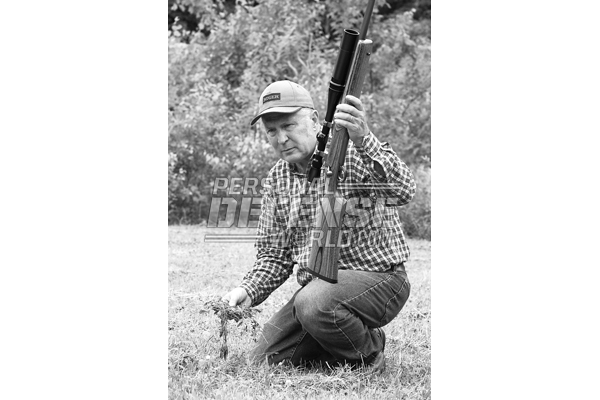 No matter what kind of hunting you do, a well sighted-in rifle is the only way to go into the field. With his Ruger Target rifle rechambered in the .220 Weatherby Rocket, the author checks for early woodchucks in the fields nearby.