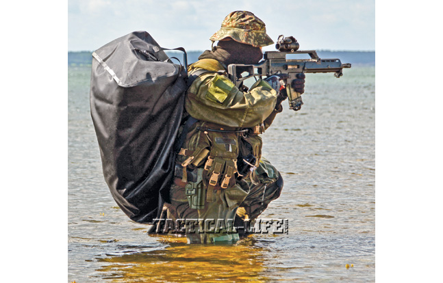 A German Navy Kampfschwimmer scans for targets with his HK G36K carbine, a modular weapon made largely of a carbon-fiber-reinforced polymer.