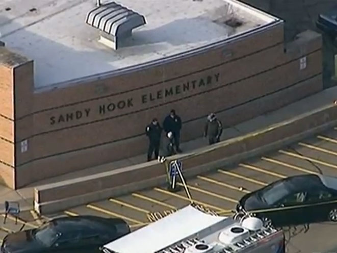 Police arrive in front of Sandy Hook Elementary School after the shooting.
