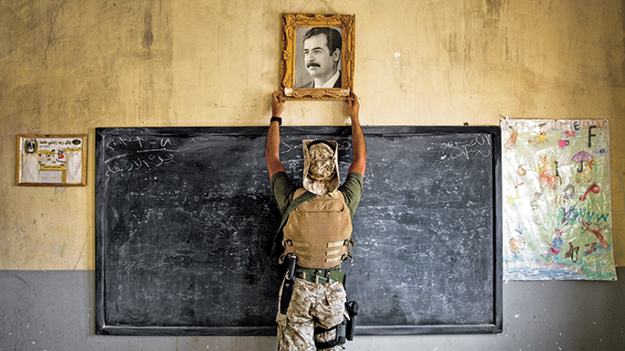Saddam Hussein's portrait was removed from a classroom by U.S. Forces.
