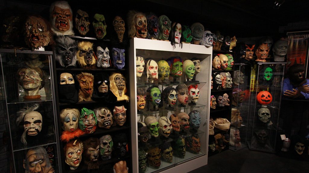 Rudy Munis, collector, masks, wall