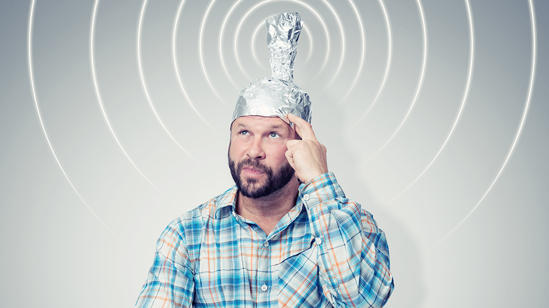 Man wearing a tinfoil hat, getting a signal!