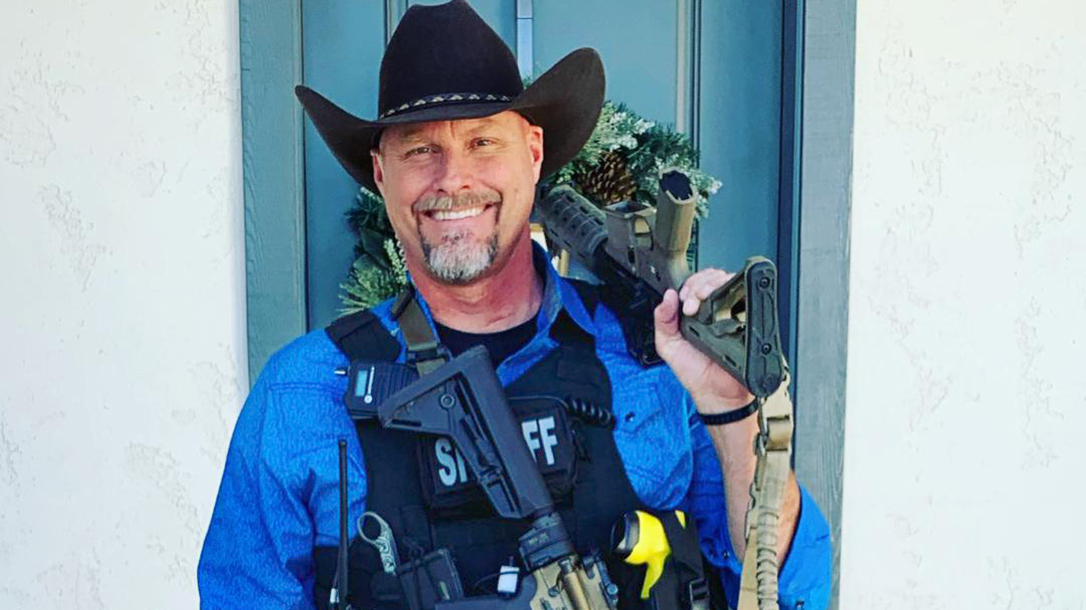 Sheriff Mark Lamb smiling with a rifle in Queen Creek, AZ.
