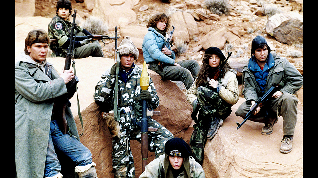 The cast of Red Dawn stands poised ready for battle.