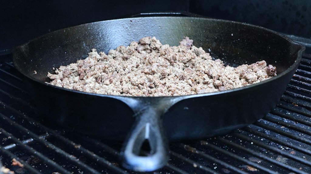 Add your ground elk to your cast-iron skillet.
