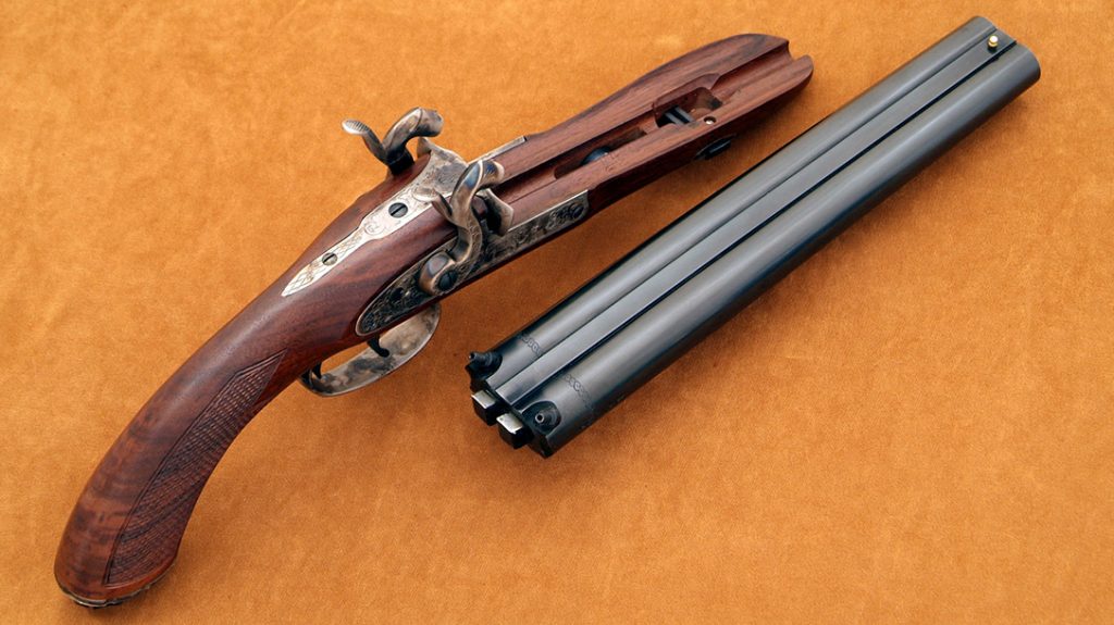 The Howdah model has the barrels welded with two central ribs, as would be a shotgun. There are two lugs on the back of the barrels that fit into corresponding recesses in the tang. The barrels are secured to the stock by a single wedge passing through the barrel tenon.