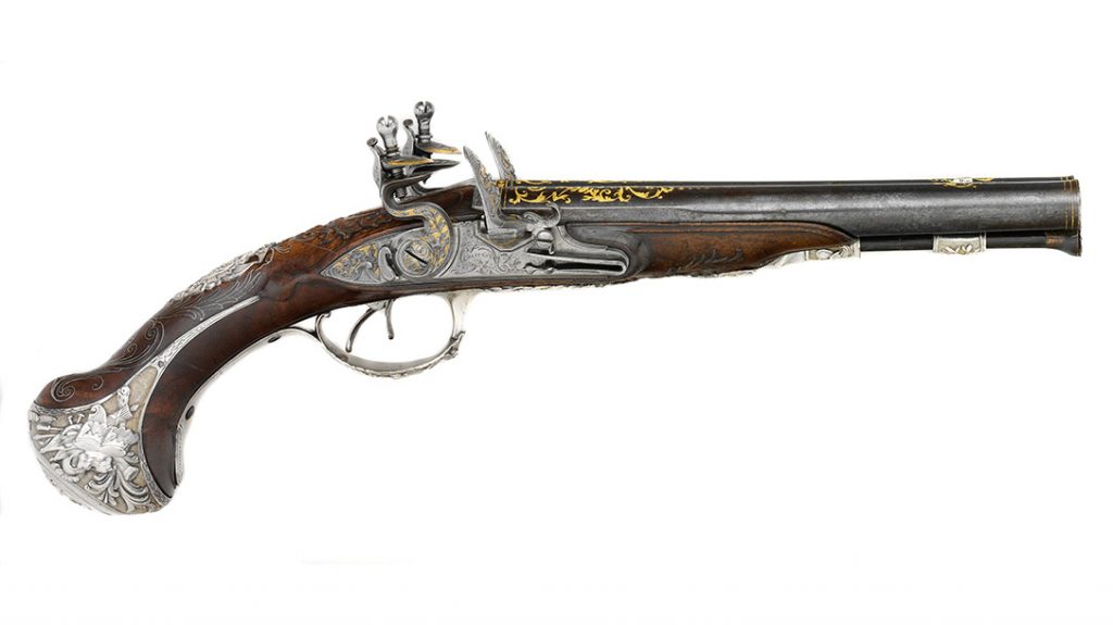Flintlock pistols with side-by-side barrels became popular in England and France in the second half of the 18th century. This luxuriously decorated French pistol exhibits the fashionable Rococo taste for asymmetry and whimsy in its elaborate parcel-gilt silver mounts and silver-wire inlay. (Metropolitan Museum of Art)