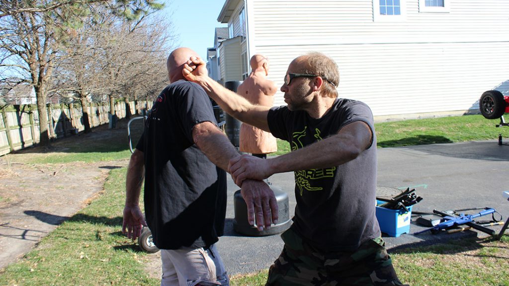 Always follow up with attacks until the fight is done. Pictured is a backfist to the ear/side of the face.