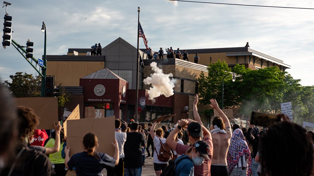 Protesters surround a police precinct, part of a larger wave of civil unrest in 2020.