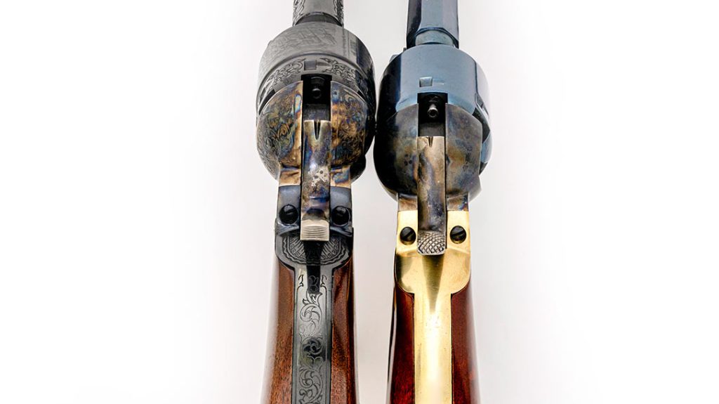 The rear sights on these Cimarron revolvers are V-notched in the hammer nose. Note the hammer spurs and the percussion cap nipples.