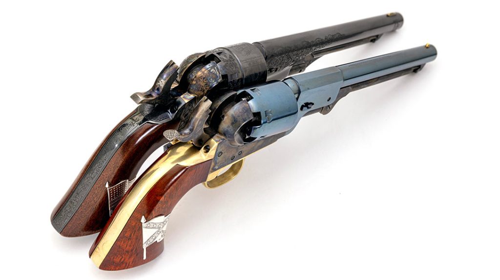 Shown at full-cock, you can see the cap nipples and the open-top design of these two Colt-designed Cimarron revolvers.