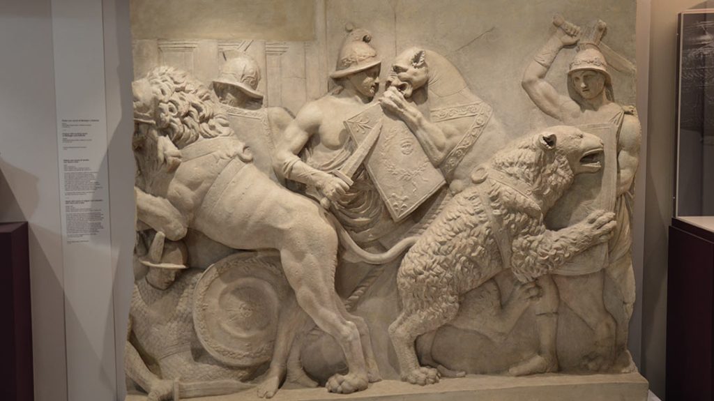 Plaster cast of a 1st century B.C. carving of Venatores fighting lions and bears in the arena. A man on the ground and another with a lion on his shoulder shows what deadly entertainment this was. Displayed at the National Archeological Museum in Naples.