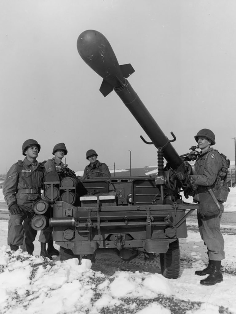 Soldiers show the Davy Crockett in firing position on the back of a Jeep.