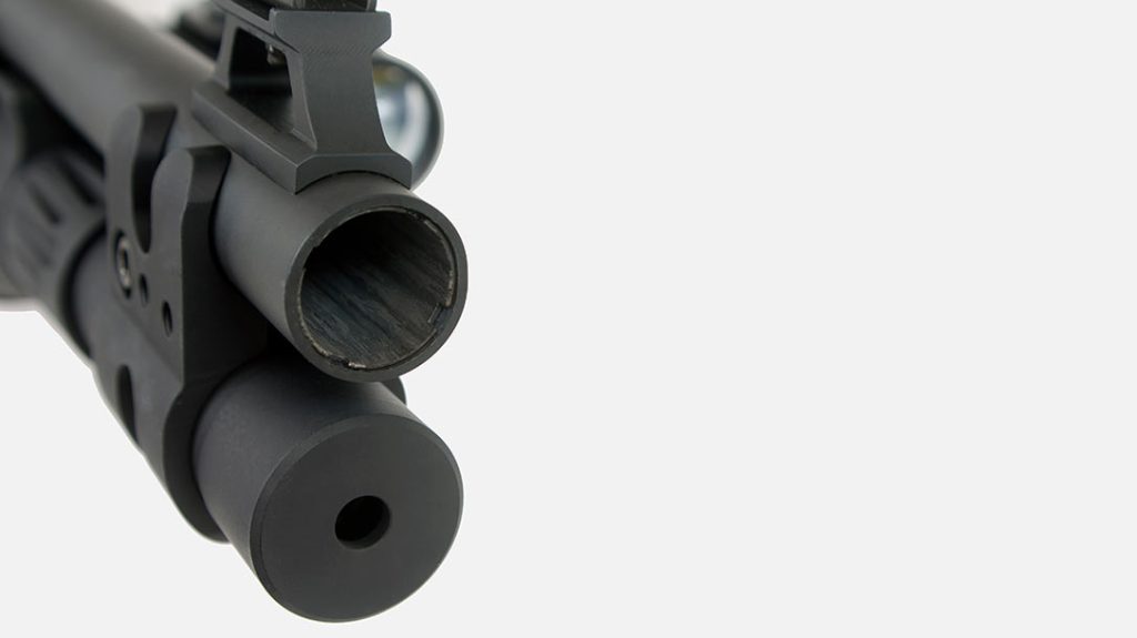 The extended magazine tube of the Langdon Tactical Beretta 1301 Tactical is held in place with a clamp that features a piece of a Picatinny rail.