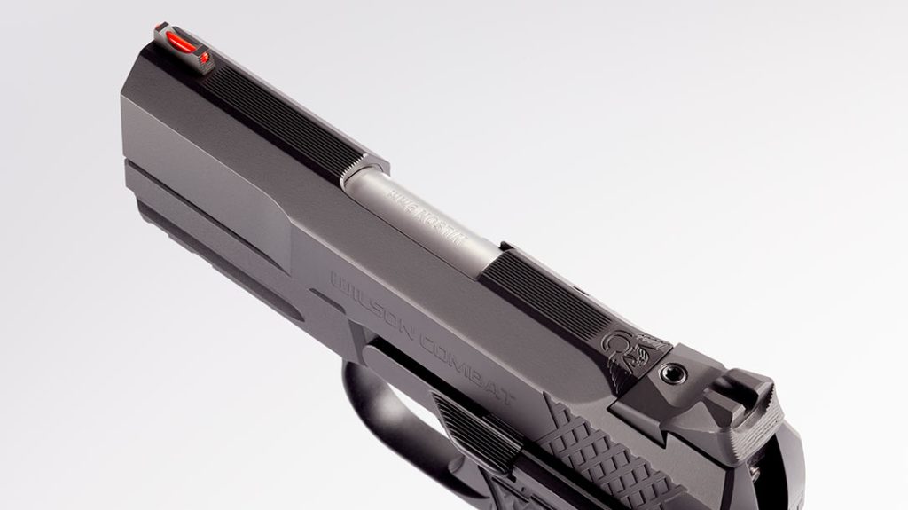The slide features a serrated flat between the sights.