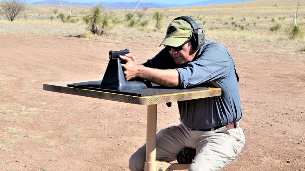 The author shoots the pistol from a DOA Tactical shooting bench rest.