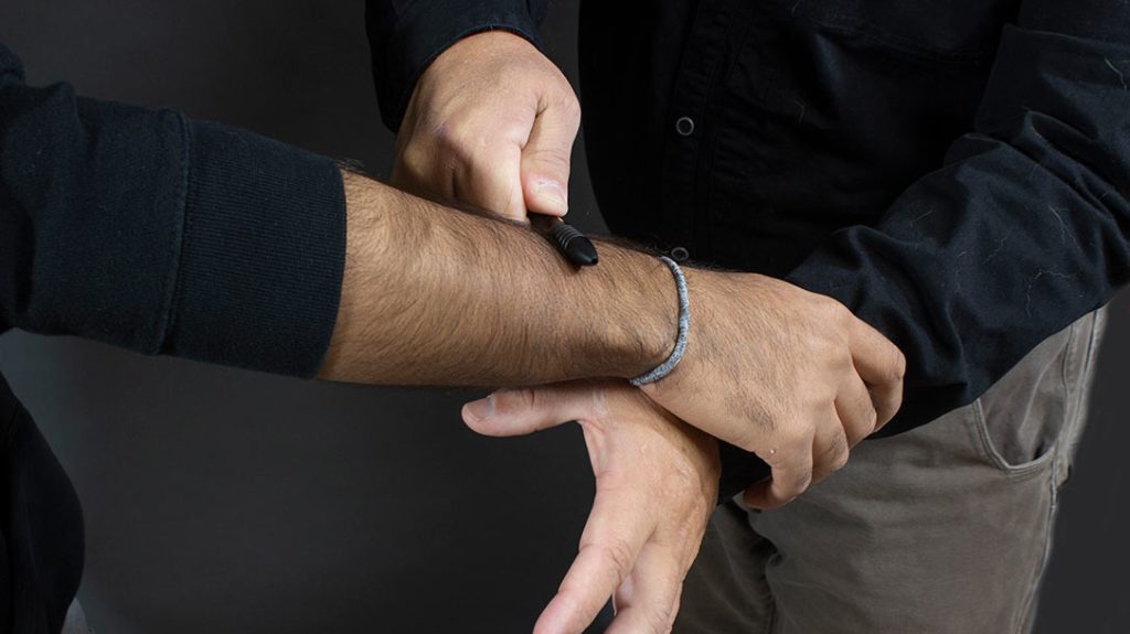 You place your pen on the wrist and apply pressure to deliver pain and physical dysfunction.