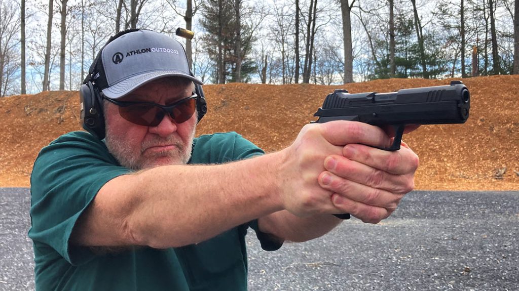 The author shooting the pistol during testing and evaluation.