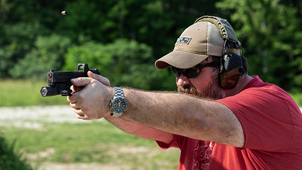 The author shooting the pistol during testing and evaluation.
