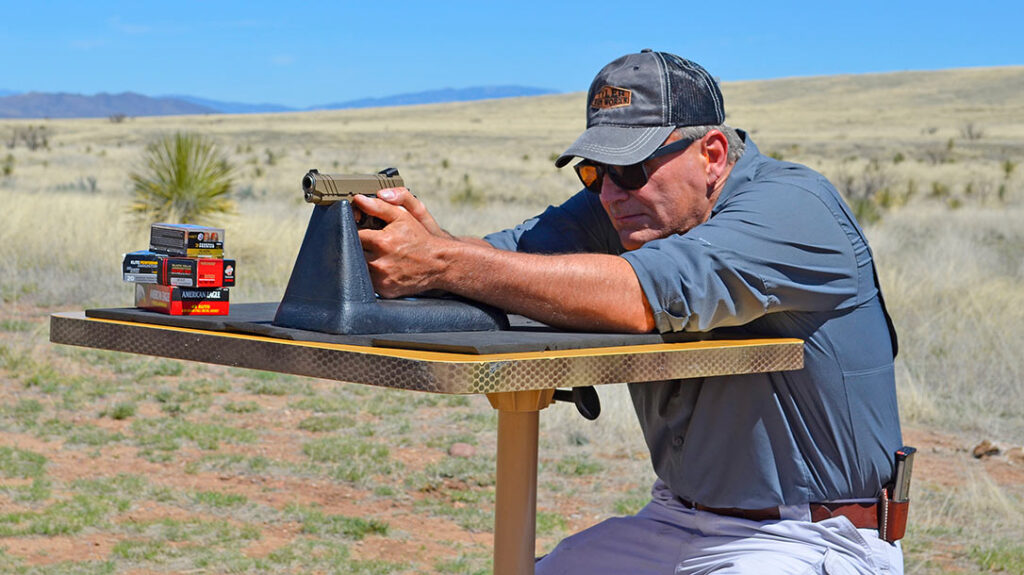 The author testing the Devil Dog Arms DDA-350 1911 from a bench for accuracy.