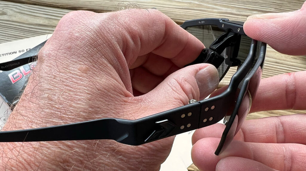 To remove the lens, pinch the nosepiece together and pull the locking mechanism to the rear.