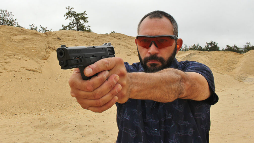 The author shooting the pistol during his range work.