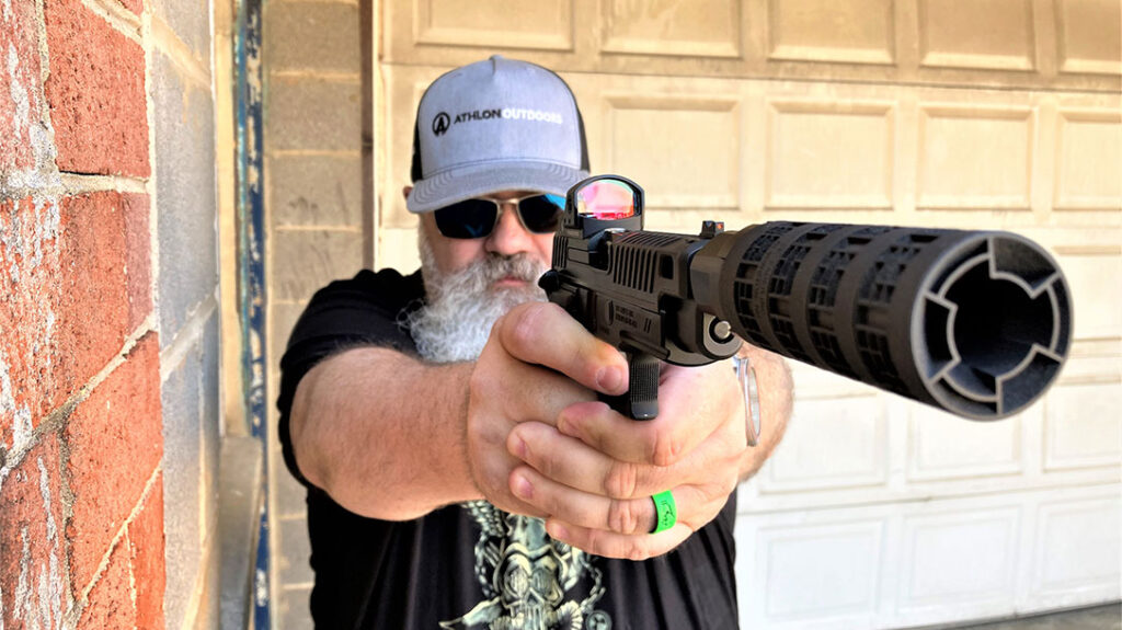 The author shoots the pistol with the MODX-9 suppressor attached.