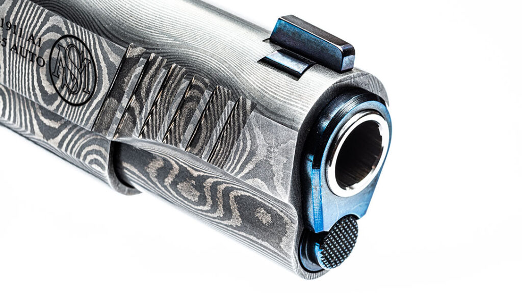 Both the bushing and front sight on the Standard Manufacturing Damascus 1911 is blued for aesthetics.
