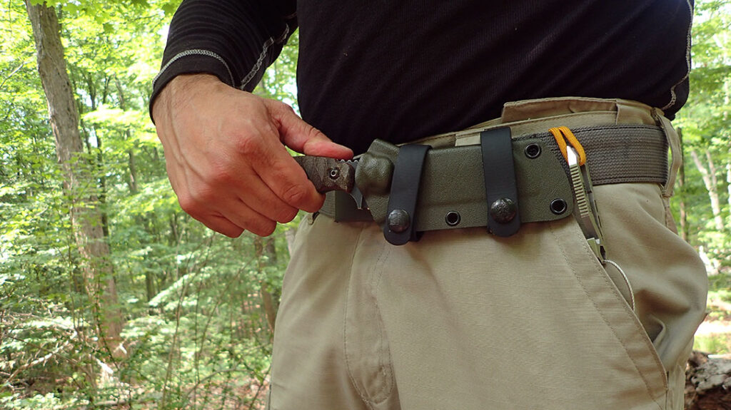 The TOPS Sheep Creek comes with a kydex sheath designed for scout carry. The author opted for a cross-draw setup instead. There was a nice place to push off with the thumb to quickly deploy the blade.