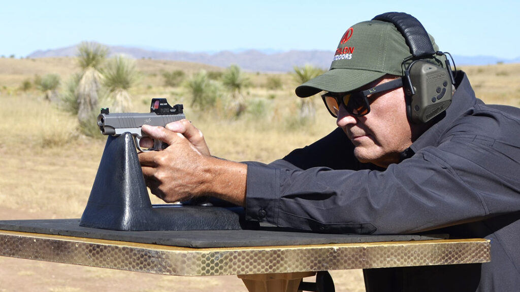 The author shooting the Kimber KDS9c from a DOA Tactical shooting bench.
