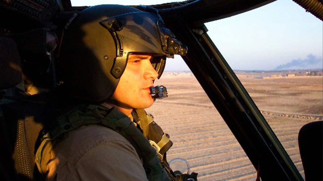 Ryan piloting a helicopter during a military training exercise.