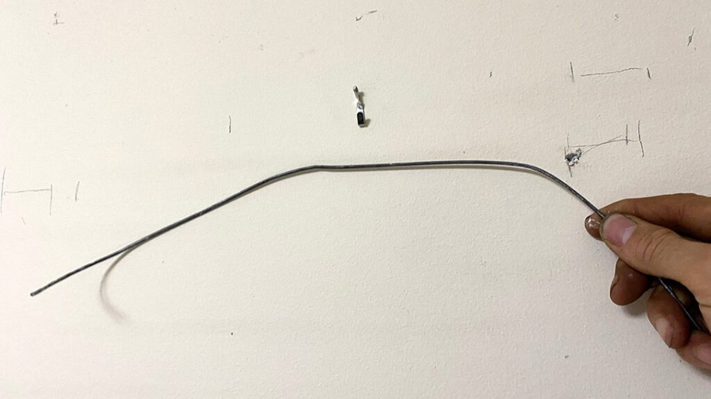 After locating the wall studs, make a probe from a wire coat hanger to sweep around inside the wall cavity where you want to install the safe to check for electrical wires and water pipes.